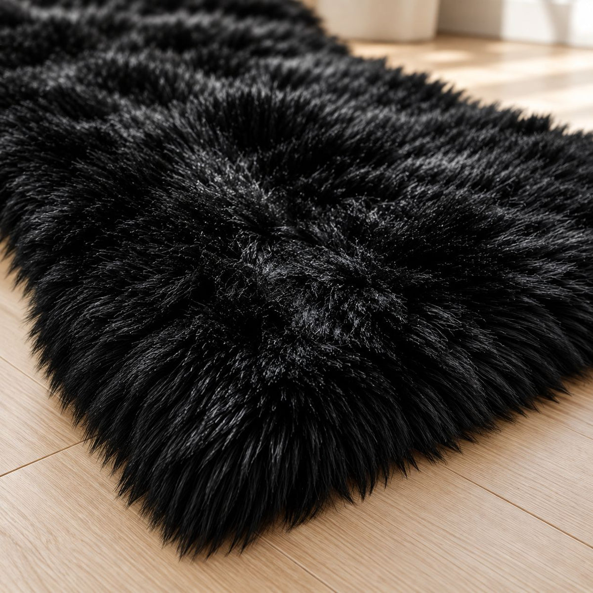 Angled close-up of black fur floor mat edge on a wood floor