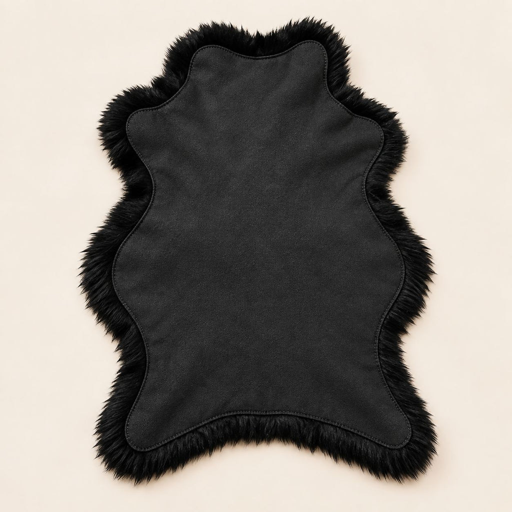 Reverse side of black fur floor mat showing lambskin suede backing