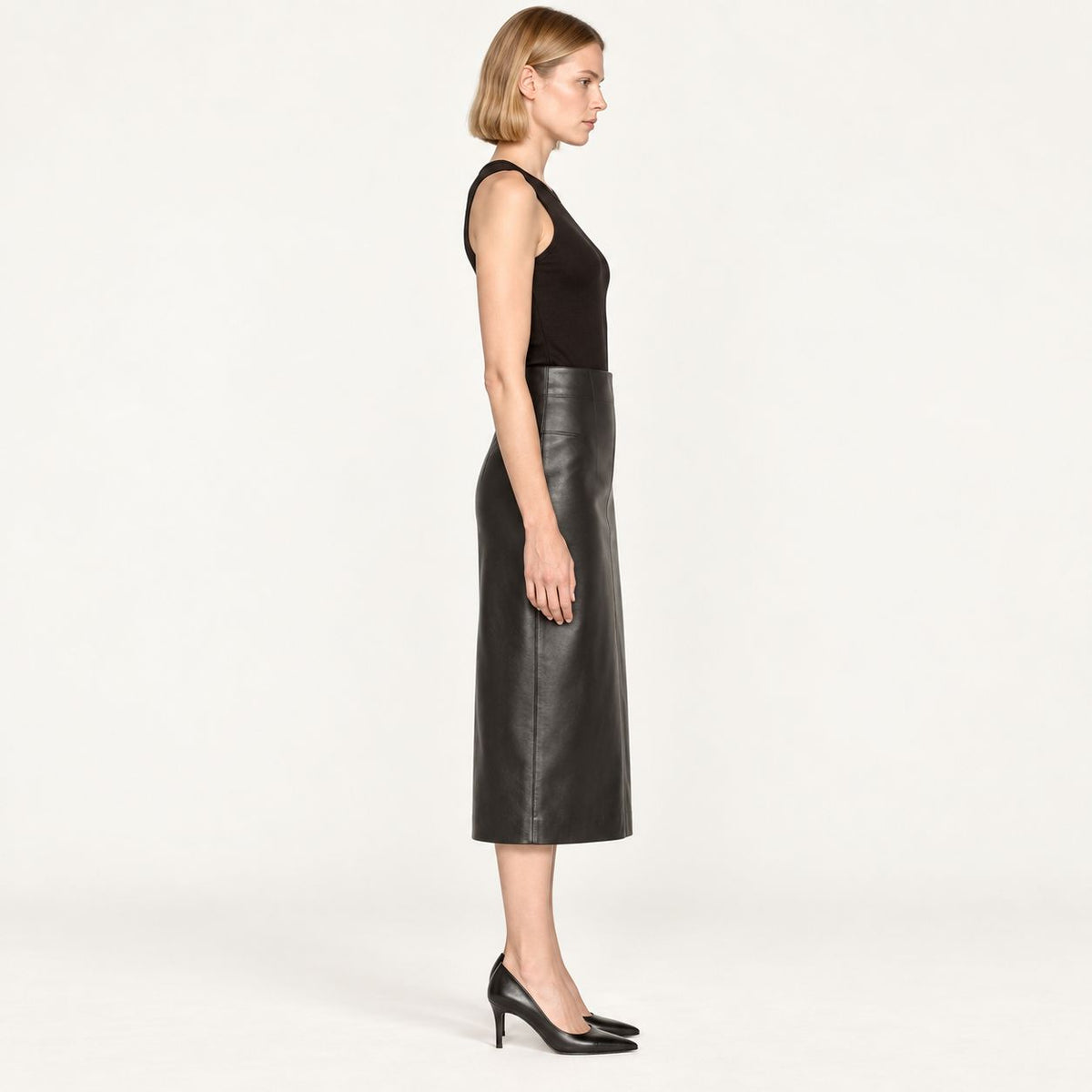 Side profile of black leather midi skirt showing A-line silhouette