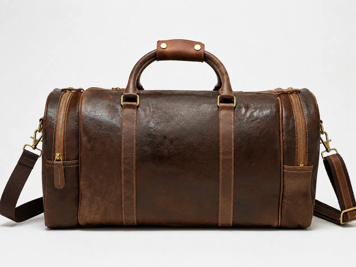 Distressed brown full-grain leather duffel bag, front view