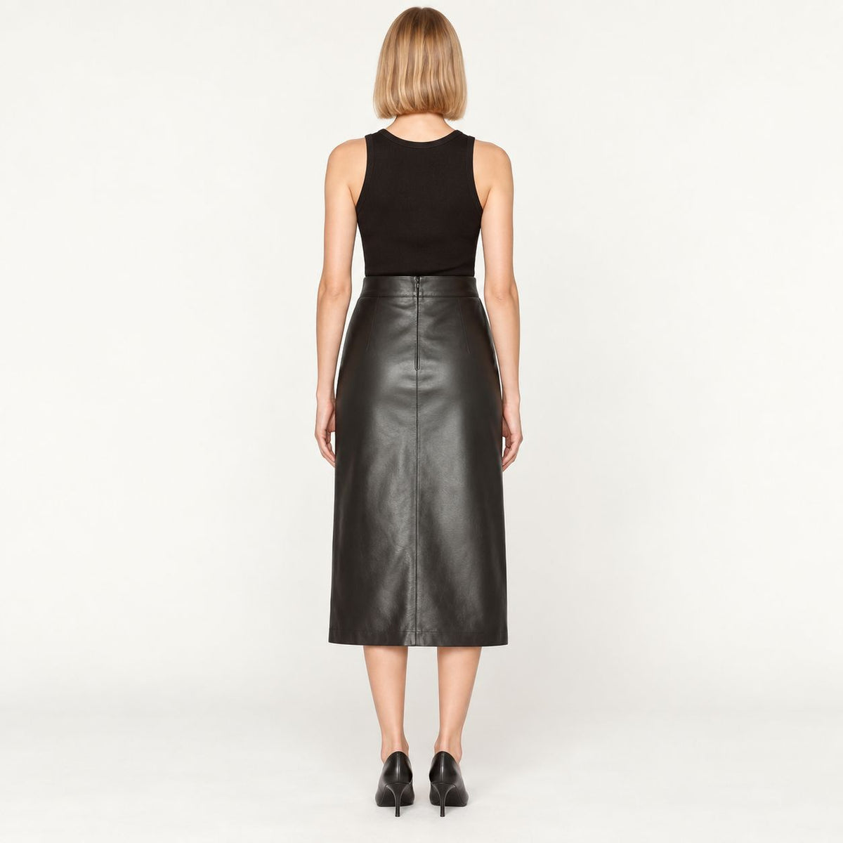 Back view of black leather midi skirt showing zip closure