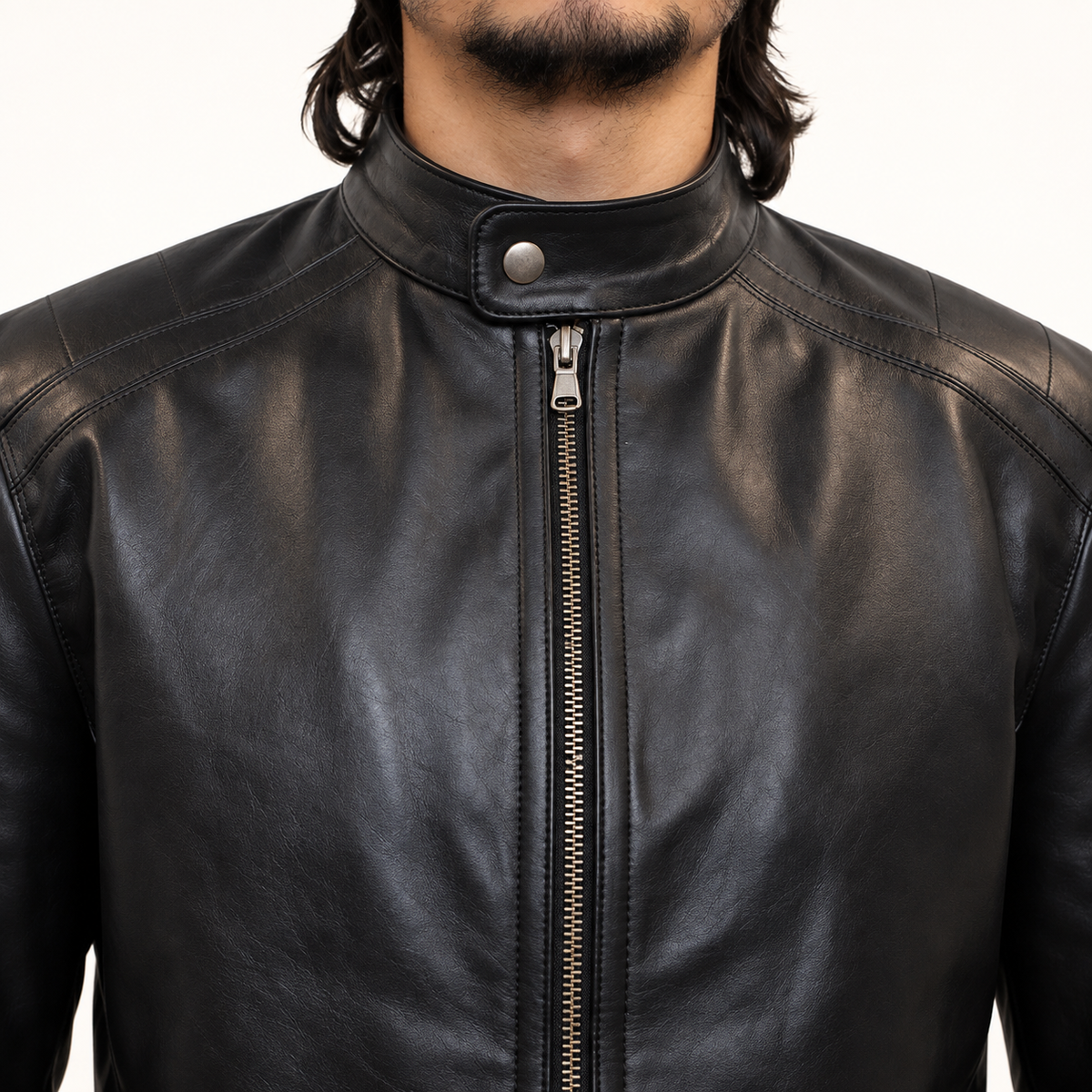 Close-up of collar, snap closure, and zipper on black leather biker jacket